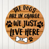 Personalized Round Metal Sign for Dog Lovers - "The Dogs Are in Charge, We Just Live Here" with Paw Prints and Bone Design - Image 1